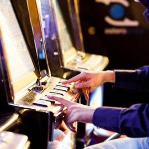 Man having playing an electronic slot machine